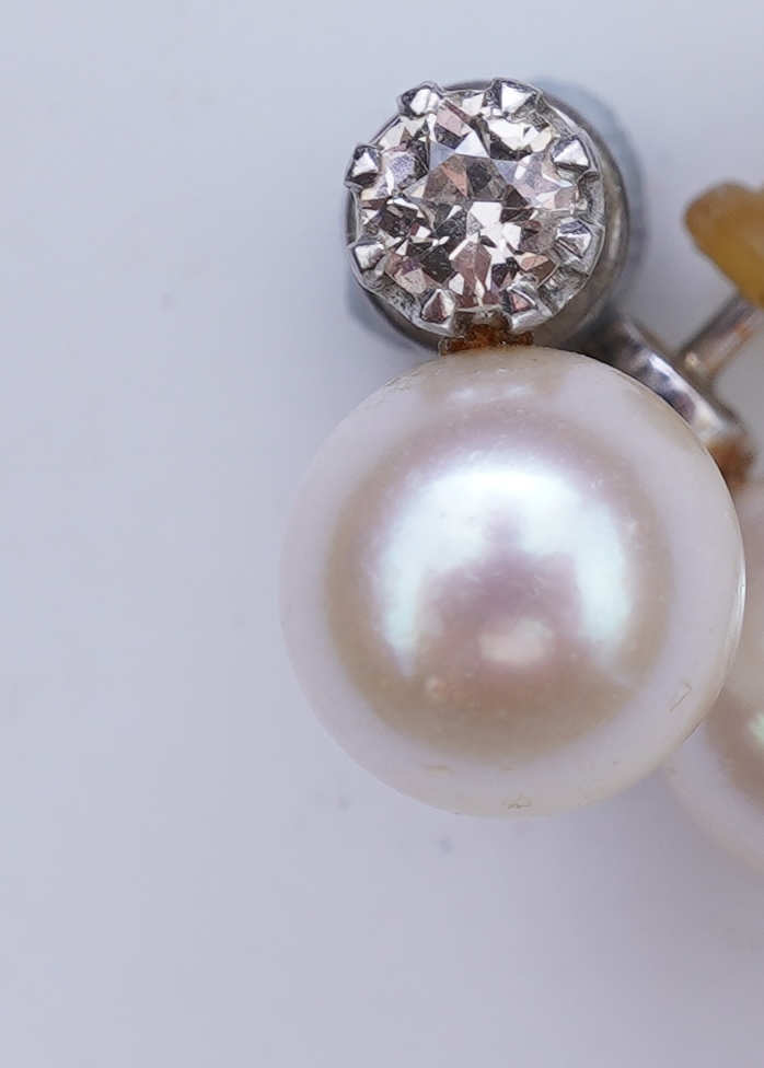 A pair of cultured pearl and diamond earrings